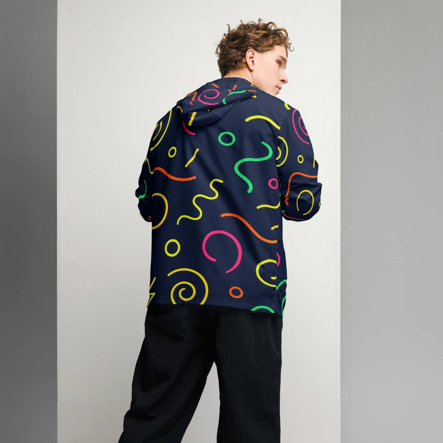 Man wearing black windbreaker with colorful abstract print, urmax sporty outerwear
