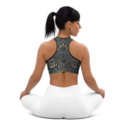 Woman in geometric print sports bra and white leggings sitting cross-legged, urmax fitness apparel