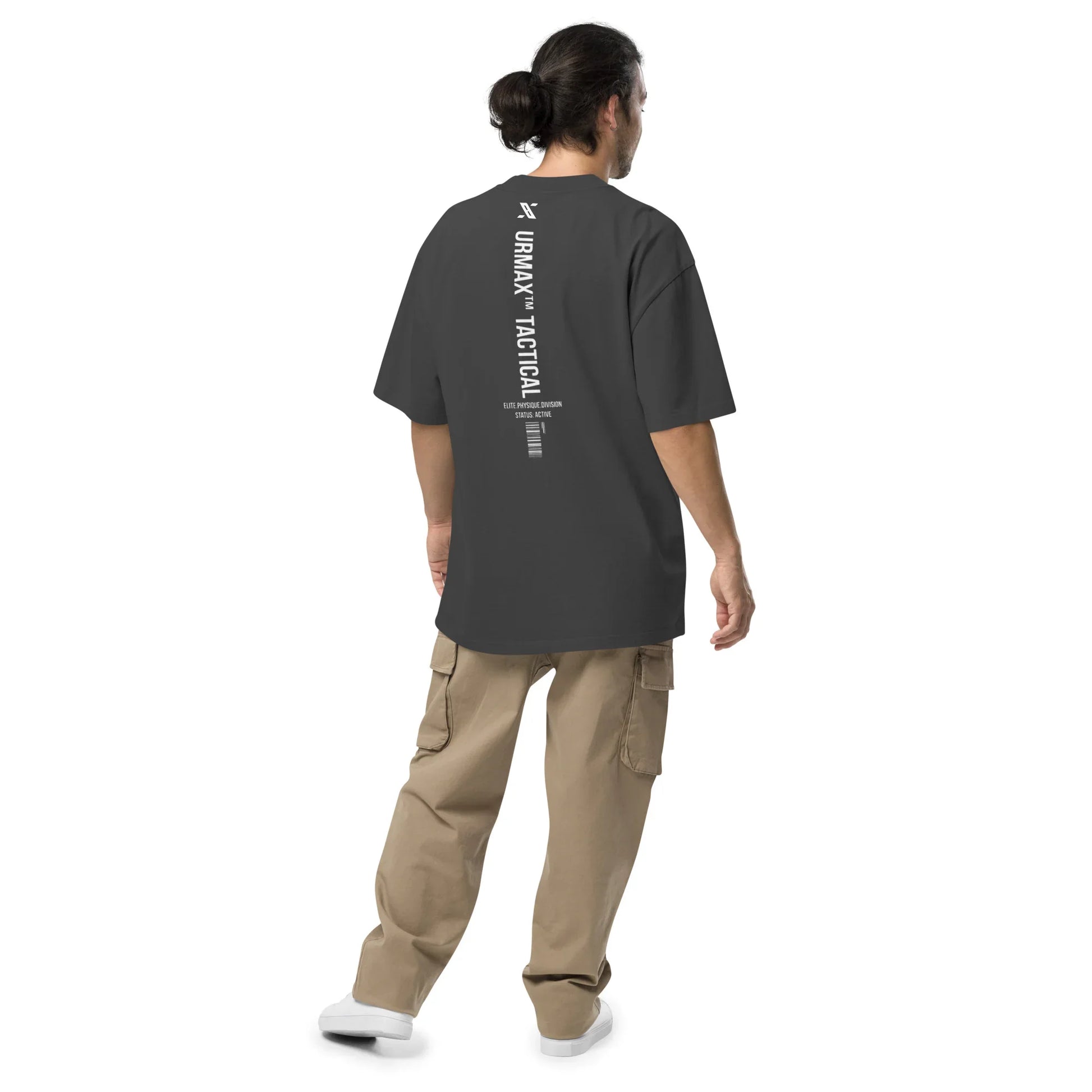 Man wearing oversized faded black URMAX tactical t-shirt with vertical back print