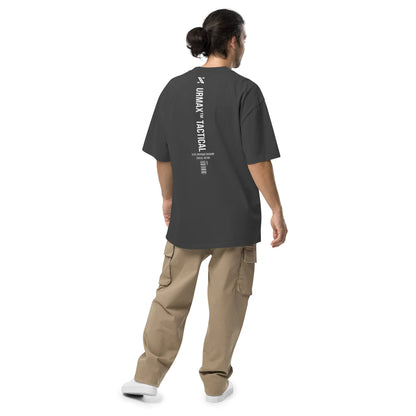 Man wearing oversized faded black URMAX tactical t-shirt with vertical back print