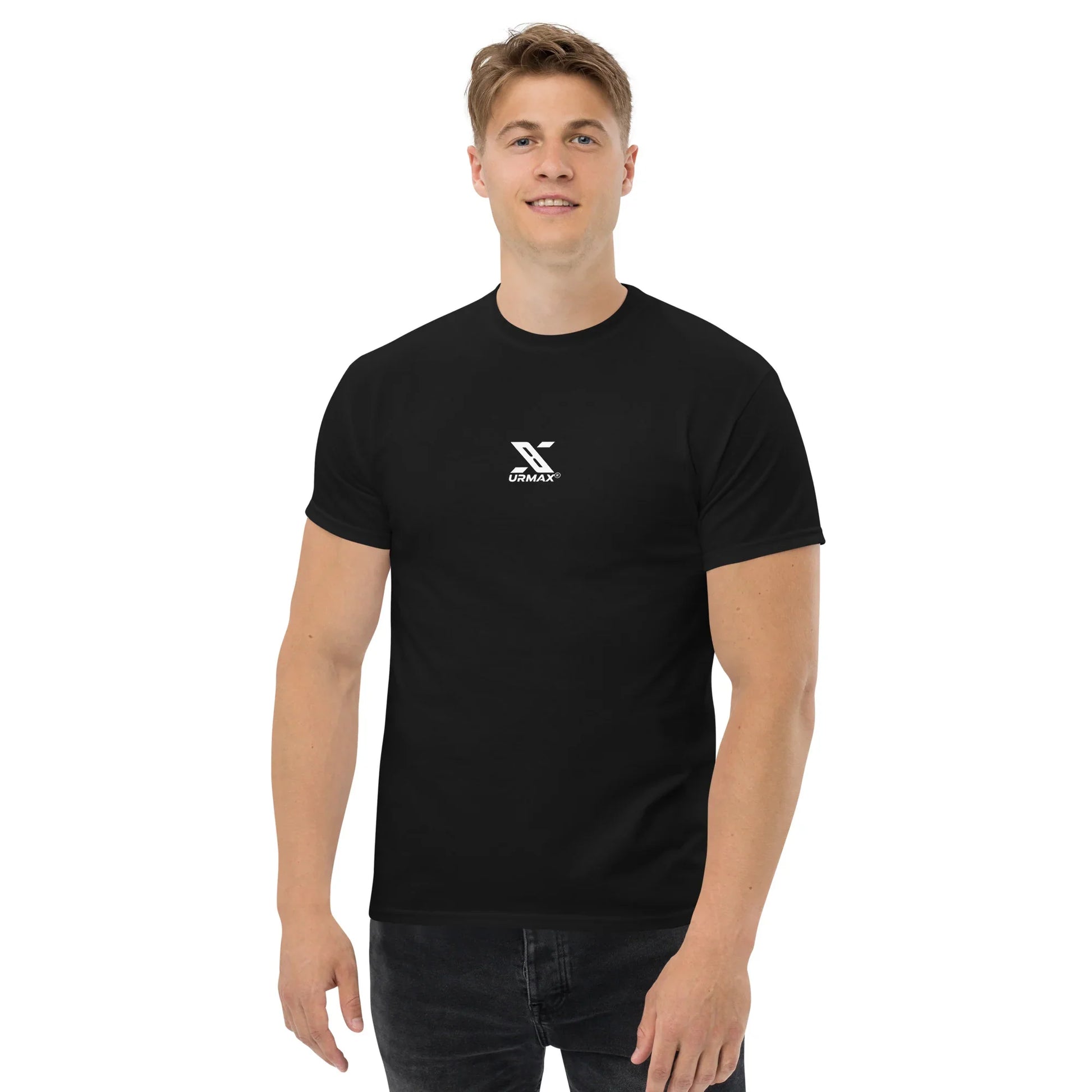 Man wearing a black URMAX unisex classic tee with white logo, front view, plain background