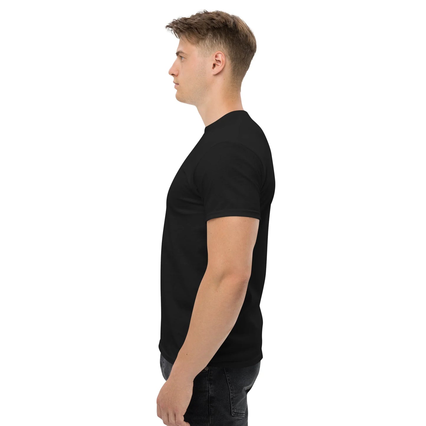 Man wearing black unisex classic tee, side view, urmax clothing, plain white background