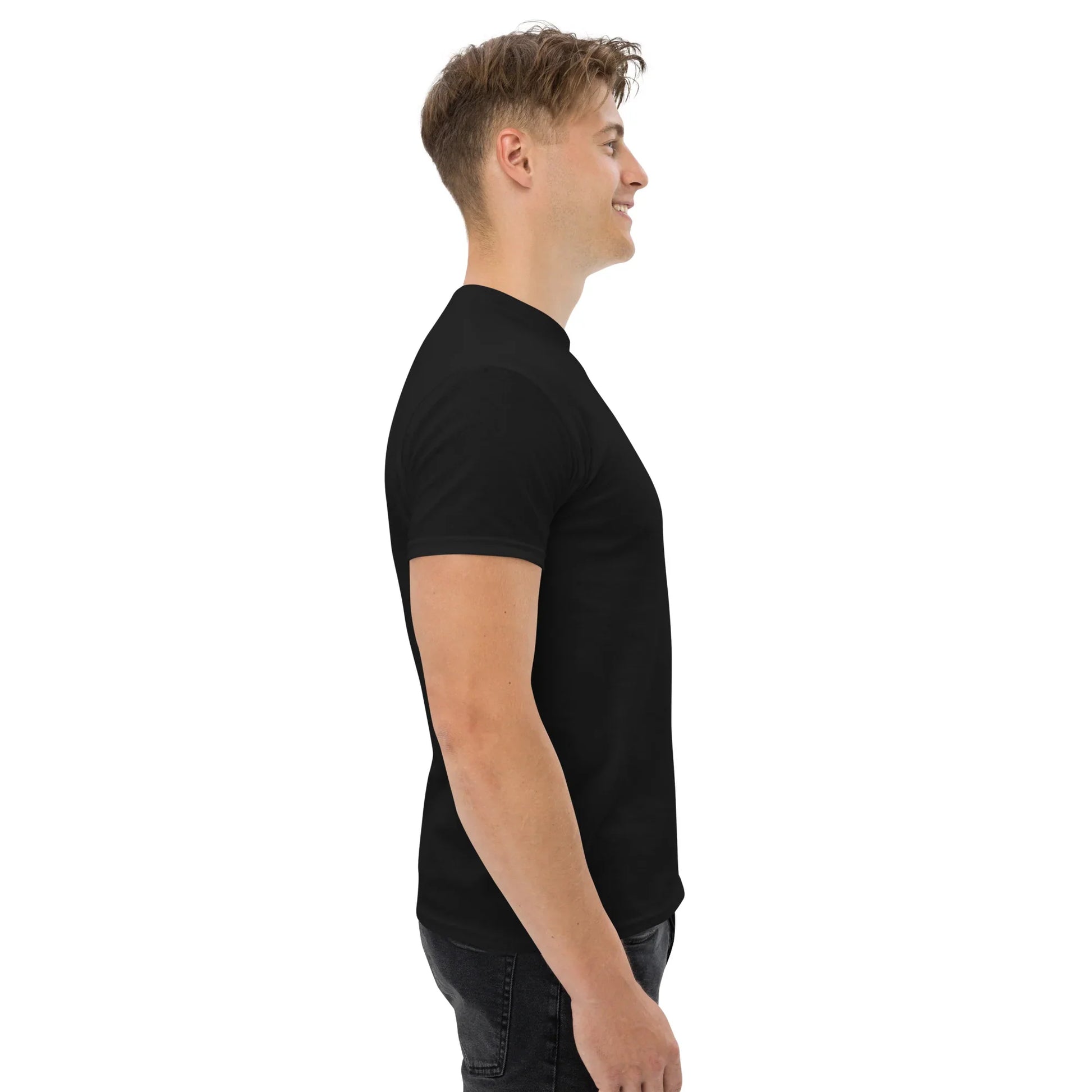 Man wearing a black unisex classic tee from urmax, side view on white background